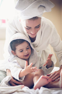 Mom & child applying therapeutic body care product