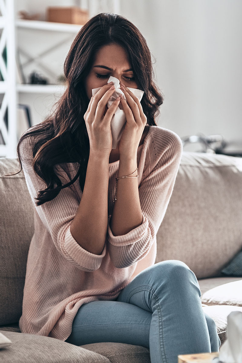 Bacterial vs Viral Infections - Woman sneezing