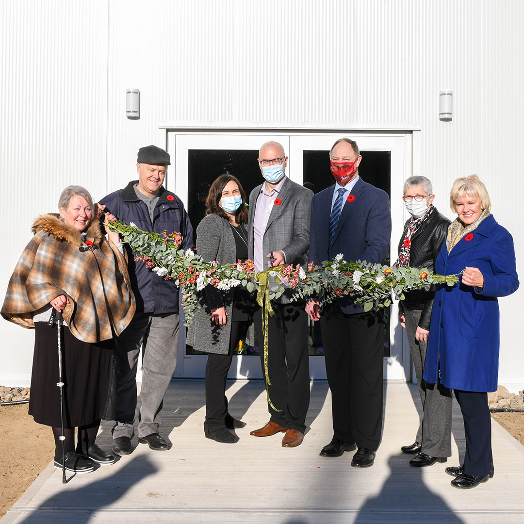 Dignitaries cutting the floral ribbon at the grand opening of St. Francis Herb Farm's new facility