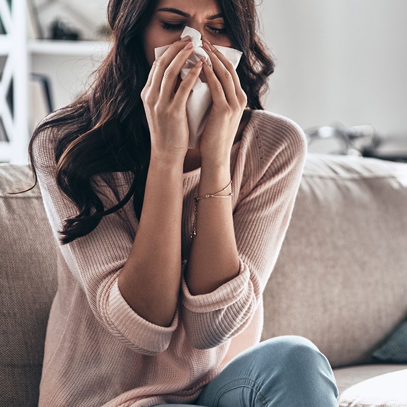 Bacterial vs Viral Infections - Woman sneezing