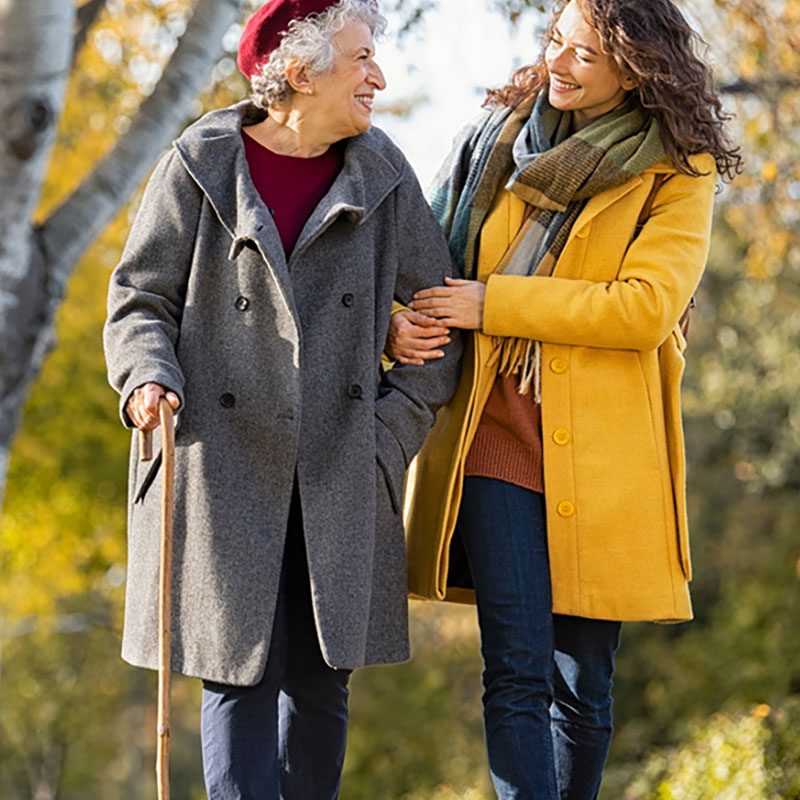 woman and mother walking outdoors in the fall colours